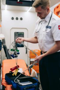 Paramedic organizing equipment in ambulance, showcasing emergency medical services.